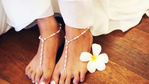 Choosing a white pedicure design with rhinestones
