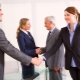 Who should greet first according to etiquette?