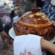 Who takes out and holds the loaf at the wedding?